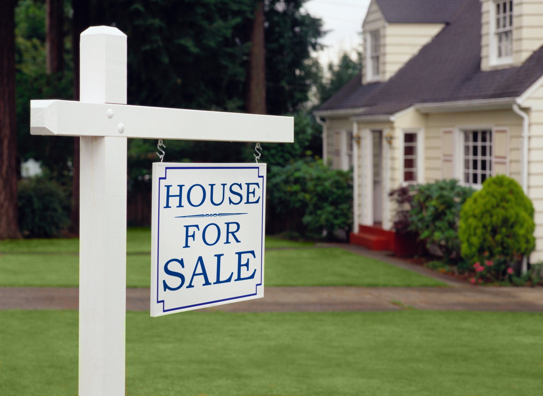 Real estate sign indicating house for sale